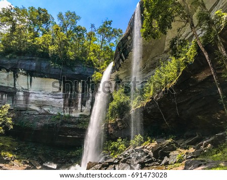 Waterfalls and rocks and natural trees.