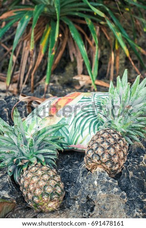 Fresh tropical exotic pineapple fruit on the beach. Parardise island of Bali. Beach bag.