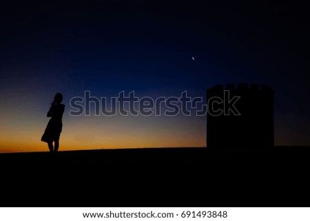 Woman with a twilight and crescent moon background. La perouse, Sydney Australia