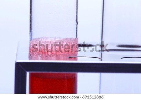 Bubble Red Liquid in group Glass Tube Lab Test tools on Stainless stand holder, Studio lighting white background isolated