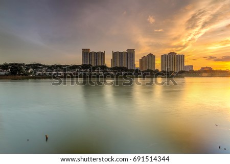 Beautiful landscape abstract citybackground and The light of sun reflection building on water.Panoramic and perspective wide angle skyscraper commercial modern city of future. pastel concept.