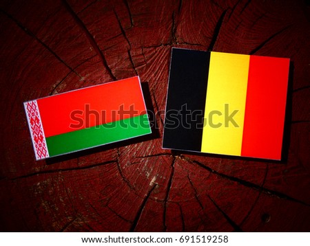 Belarus flag with Belgian flag on a tree stump isolated
