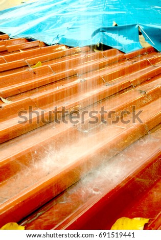 Orange roof tiles and rainwater in the rainy season