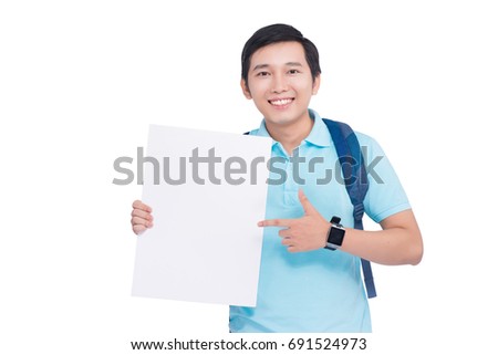 Cheerful student holding educational materials and pointing to blank paper.