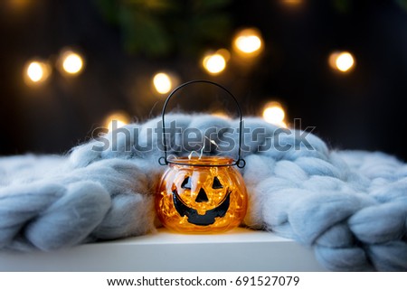 Halloween pumpkin and plaid with Fairy Lights on background