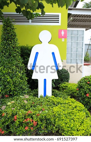 Female bathroom symbol in the garden