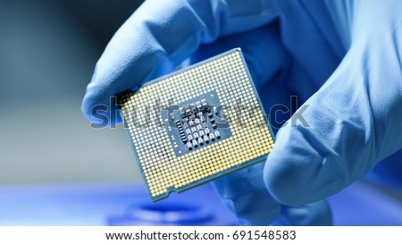 Close-up Presentation of a New Generation Microchip. Gloved Hand Holding Piece of Technological Wonder. Royalty-Free Stock Photo #691548583