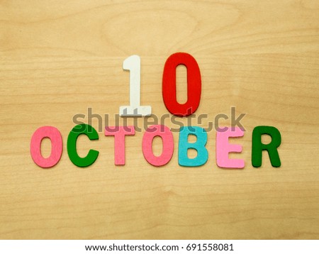 OCTOBER word made with wooden alphabet shape