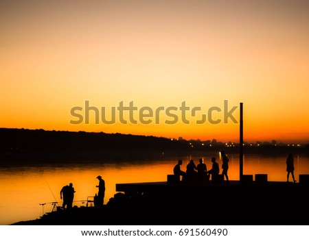 People on the background of the sunset