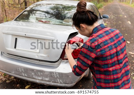 woman using mobile smartphone take photo car crash accident of the damage to the car for accident insurance