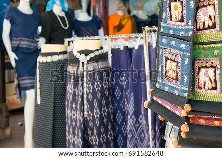 Traditional Thai silk cloth in fashion store. Black silk skirt and silver belt thai style.
