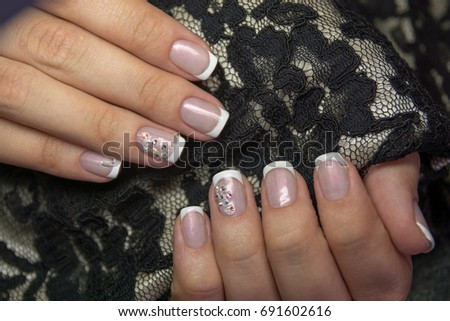 Lacquer on the nails of the hands. Fresh French manicure