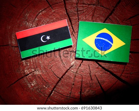 Libyan flag with Brazilian flag on a tree stump isolated