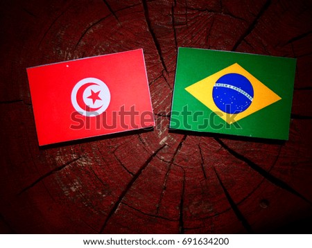 Tunisian flag with Brazilian flag on a tree stump isolated