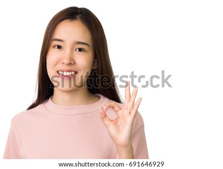 Portrait of young beautiful asian female showing ok hand sign isolated on white background.