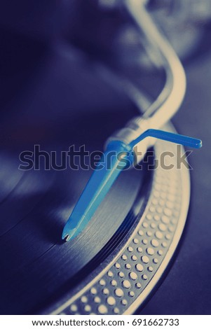 DJ turntable play analog record with music. 