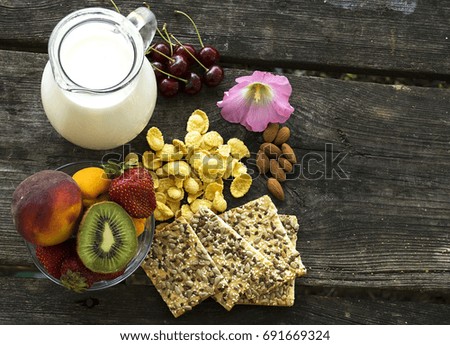 Healthy breakfast:  cherries, dates, strawberries , kiwi ,almonds, breads , banana,milk ,almonds and corn flakes