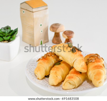 Salty croissant pastry rolls placed on a white table