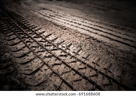 dirt wheel track on earth Royalty-Free Stock Photo #691688608