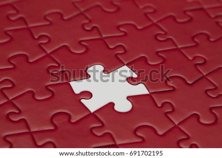 Red jigsaw puzzle and one piece white.  