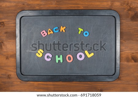 Back to school concept - colorful foam letters on chalkboard