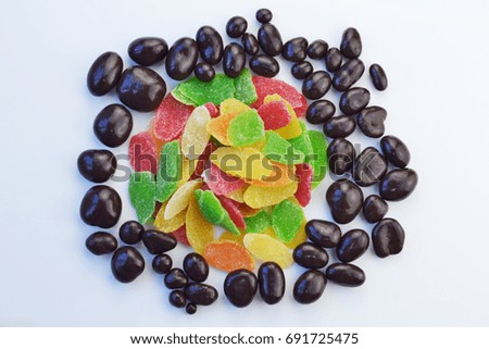 Hazelnuts in chocolate and fruit candied fruits. Orange, lemon, kiwi, pineapple
