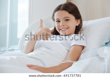 Happy delighted girl showing thumbs up gesture