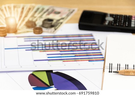 finance and calculate with desk about cost on wooden table. 
calculator and coins on the background of dollar banknotes at home office.
finance concept.
(selective focus)