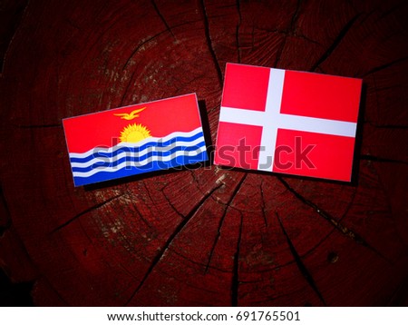 Kiribati flag with Danish flag on a tree stump isolated