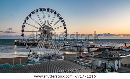The Victorian Brighton Pier and the Brighton wheel at sunset Royalty-Free Stock Photo #691771216