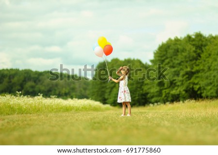 a little child with balloons