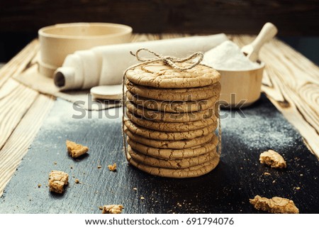Domestic stacked biscuit sweet cookie with the sesame,peanuts,sunflower background on wooden table close up 