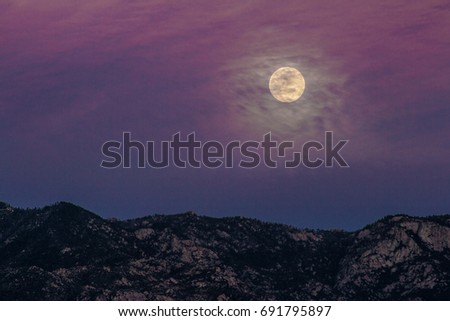 The moon rising over the Santa Catalinas.