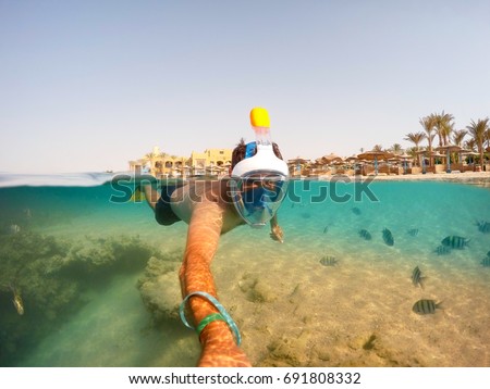 Snorkel swim in underwater exotic tropics paradise with fish and coral reef, beautiful view of tropical sea. Marsa alam, Egypt. Summer holiday vacation concept Royalty-Free Stock Photo #691808332