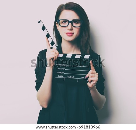 portrait of the beautiful young woman with slapstick on the white background
