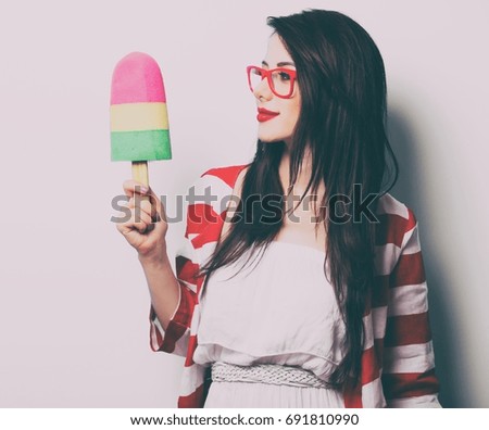 portrait of the young woman with ice-cream toy on white background
