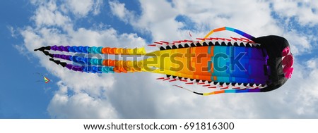 Big Chinese dragon kite in the blue sky and clouds
