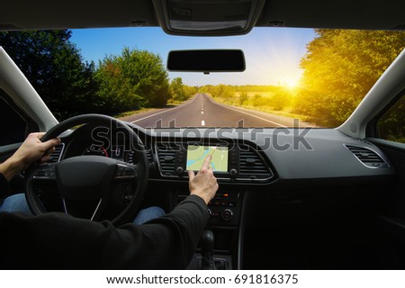 Man hand using GPS navigation inside car Royalty-Free Stock Photo #691816375