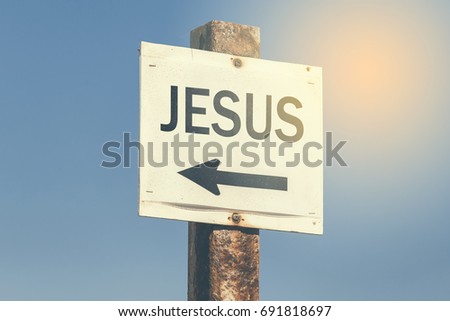 Jesus word and arrow signpost on clear sky background. Motivational sign. Vintage style.