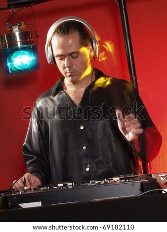 Disc jockey working at discotheque.