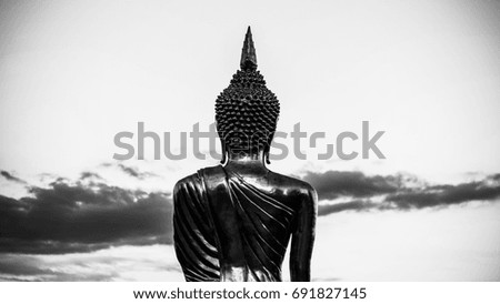 Black and white picture of Behind the statue Buddha and sky