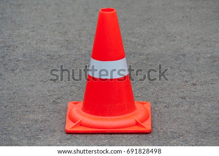 Orange traffic cone on asphalt 