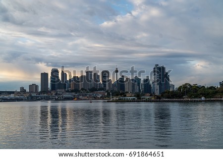 generic modern cityscape with water reflection in cloudy daytie, harbor city with downtown architecture in business district