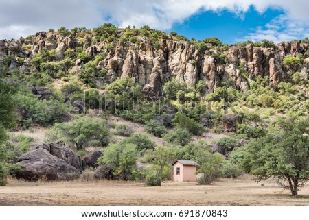 Small military guard shack on west Texas landscape on Fort Davis with mountains in background