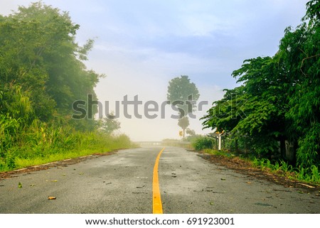 The road and fog in mountain with sunlight on morning at Phrae Northen Thailand.