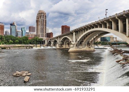 Minneapolis downtown skyline and Third Avenue Bridge above Saint Anthony Falls, Mississippi river. Midwest USA, Minnesota state.