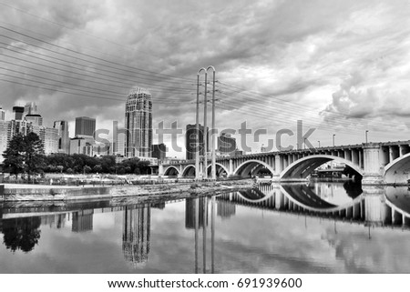 Minneapolis downtown skyline and Third Avenue Bridge above Mississippi river in black and white. Midwest USA, state of  Minnesota.