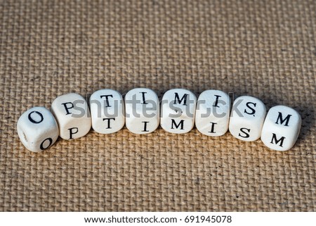 optimism word made from toy cubes with letters