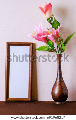 Empty photo frame with flower vase, still life photo
