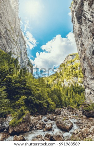 wonderful sunny mountain scenery. blue sky over the river. in canyon in mountains gloving in sunlight.  gorgeous unusual scene. Romania- Carpathian Mountains. Bicaz Canyon ( Cheile Bicazului ) . 